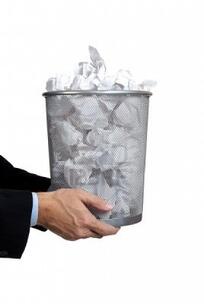 5901042 business man holidng a trash can full of papers on a white background with copy space